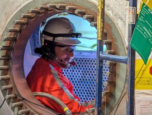 A technician inspects a heat pump system as part of the extensive maintenance and upgrades underway for the restart of the Crane Clean Energy Center. Courtesy: Constellation Energy.